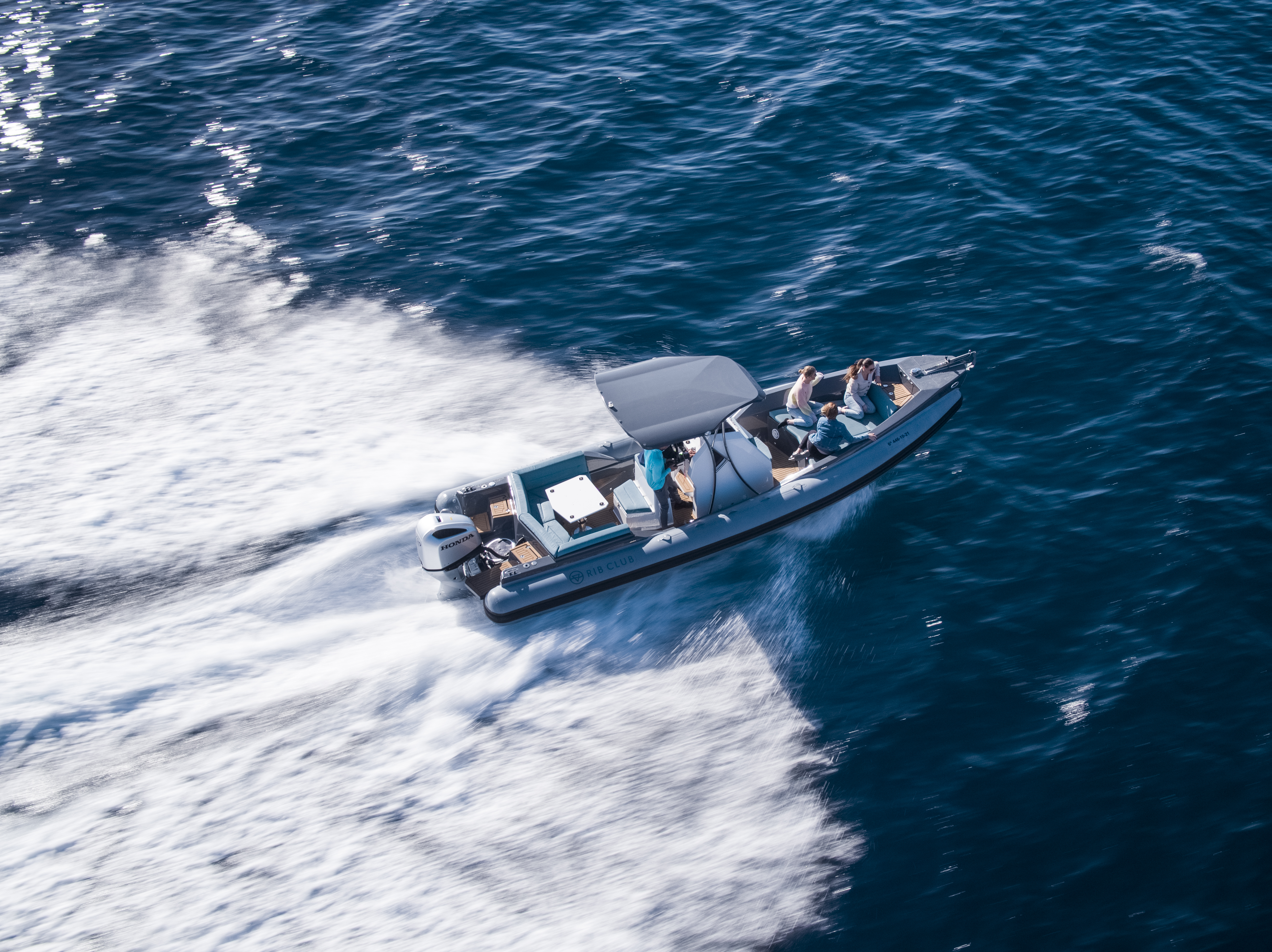A group of people, part of a premium boat club, enjoying a day out in the water with a rib without any hassle.
